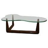 A Robsjohn-Gibbings Free-form Wood & Glass Table.