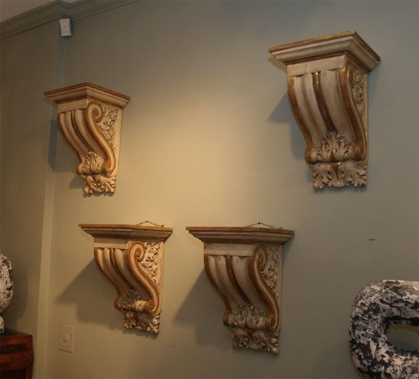 A Set of Four Classical Painted and Parcel Gilt Wall Brackets