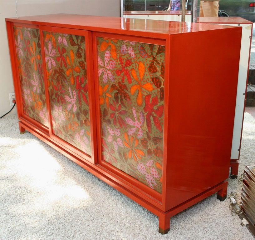 Red lacquered wood sideboard by Harvey Probber. Features interior shelves and enameled metal doors.<br />
<br />
<br />
View our complete collection at www.johnsalibello.com