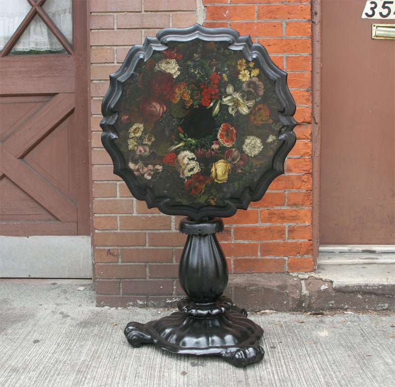 A fine painted and floral decorated scalloped top papier mache tilt/top table.
