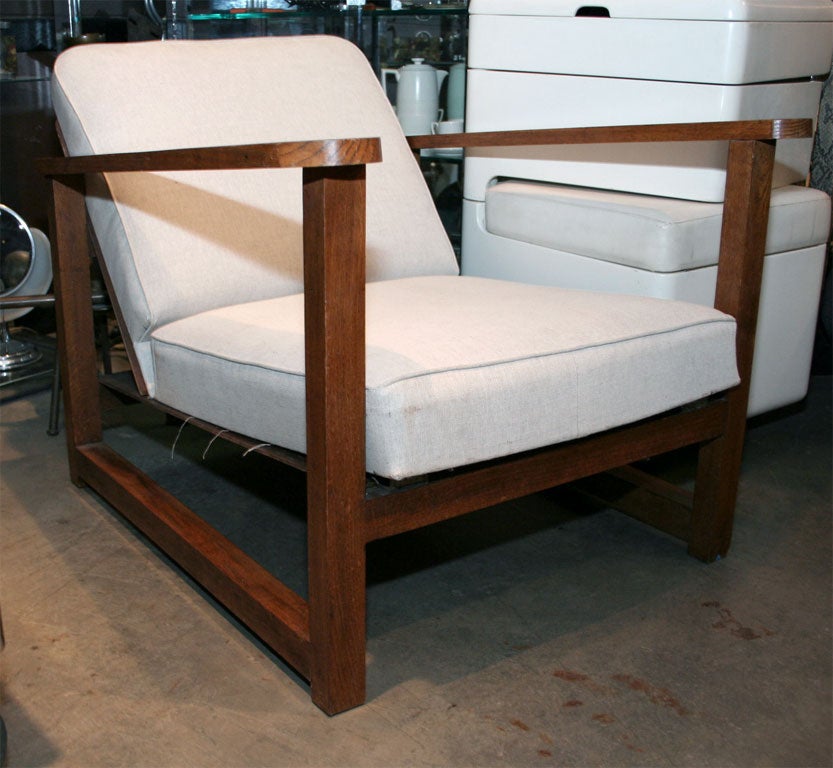 Substantial and comfortable wood chairs with canvas cushions. Perhaps yachting chairs or club chairs.
