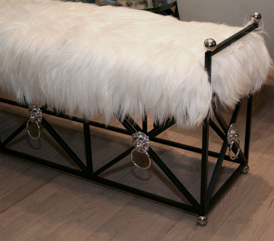 Wrought iron bench by Jansen decorated with chrome plated, bronze lion heads and rings.