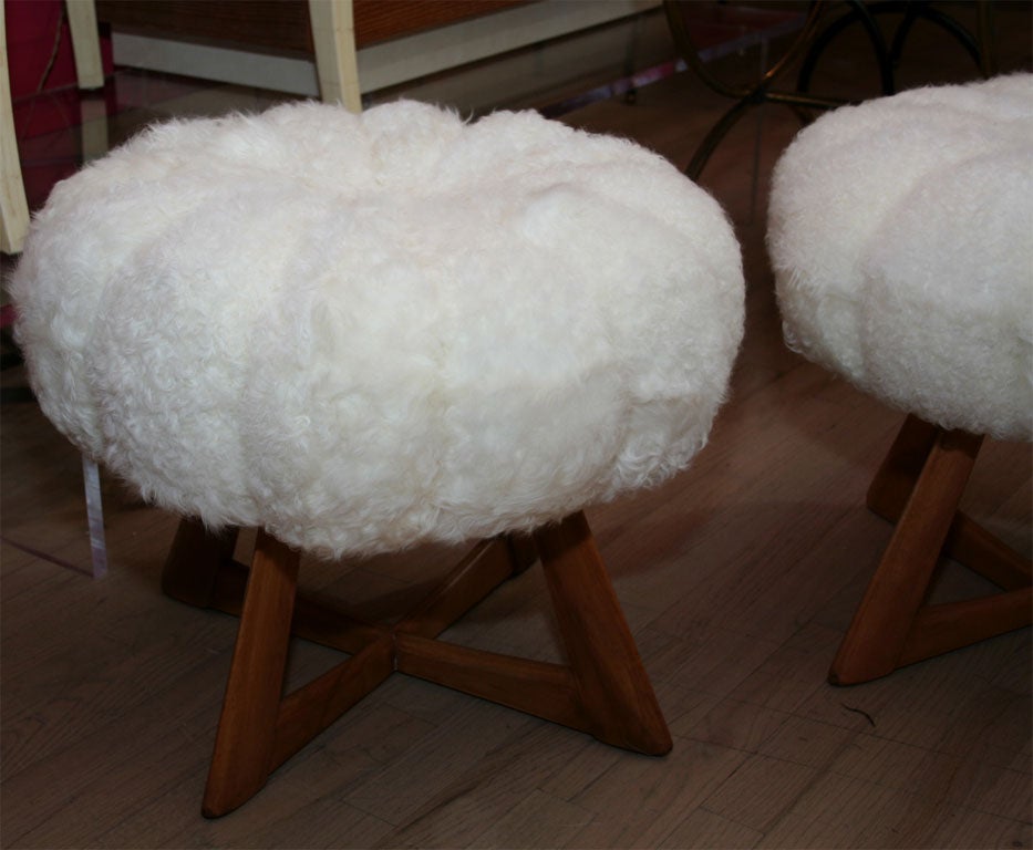 Whimsical pair of stools by Heywood Wakefield, named the Kohinoor. They are upholstered in faux shearling with tufts in the center.