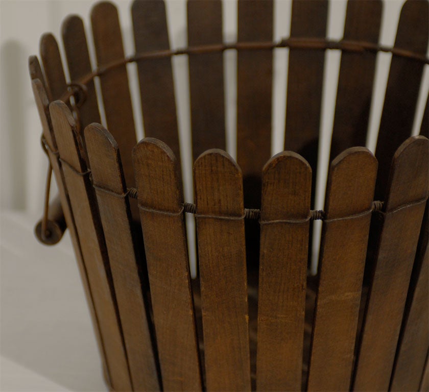 A rare Shaker basket from the community of Pleasant Hill, Kentucky.  The Pleasant Hill community was the only one to have made these baskets, and they date to the late 19th century.  The wood slats are held together with heavy wire at the top, and