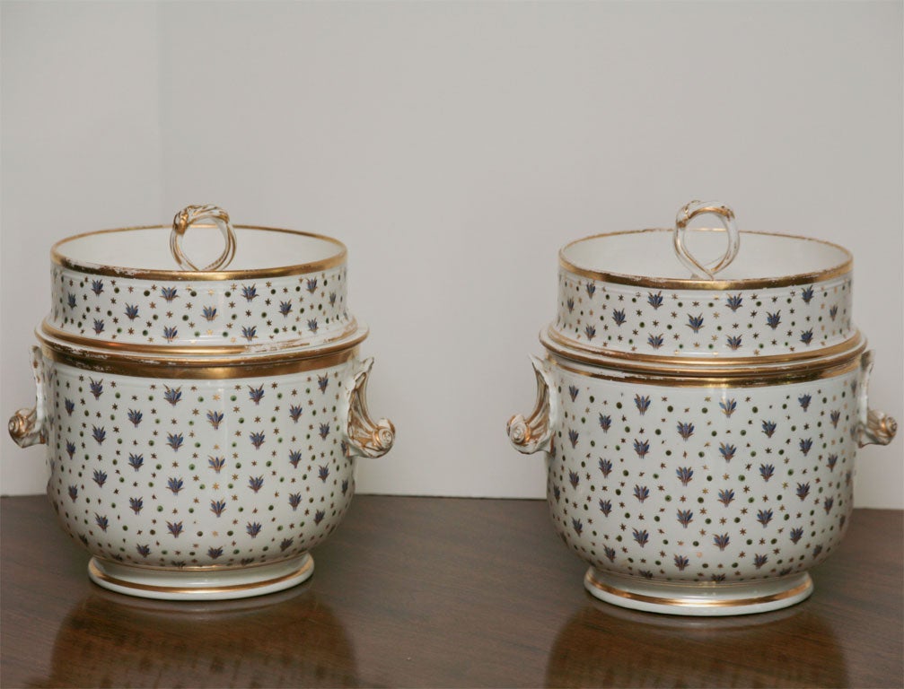 Wonderful matching pair of hand-painted fruit coolers with original fitted inserts. Shell handles and subtle blue, green and gold hand-painted decoration in the French taste. These would also make a wonderful pair of cachepots.