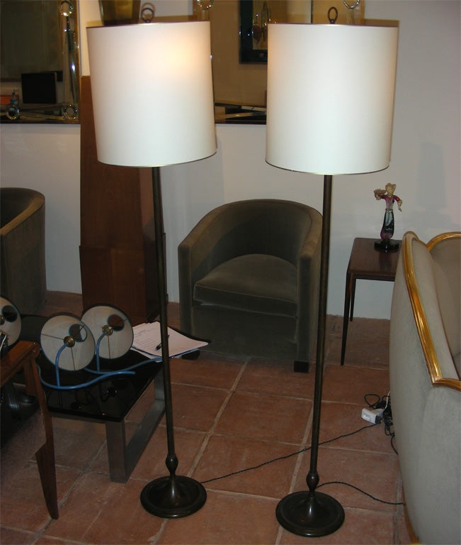 Two 1940s floor lamps attributed to Jean-Charles Moreux in oxidized bronze with new shades. Two lights.