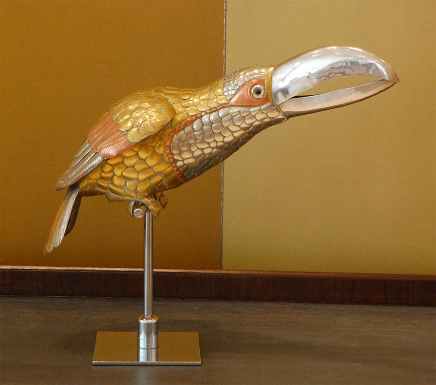 Charming mixed metal toucan sculpture on stand designed by Sergio Bustamante in the 1970's.  The bird is signed on the beak and numbered 15/100 (please see detail shot).