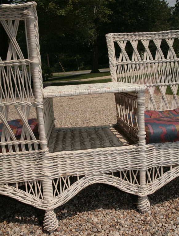 Very rare American antique wicker tete-e-tete with attached center  table.  Also known as a conversation chair and 