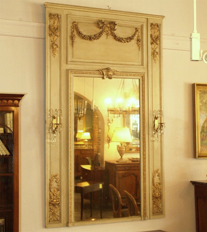 Antique French painted trumeau with sconces.