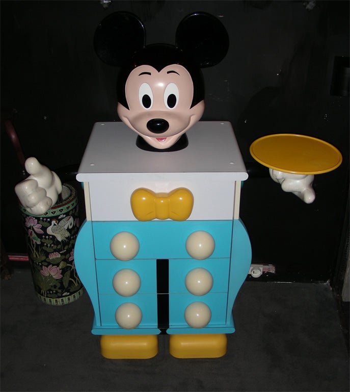 Chest-of-drawers shaped like Mickey Mouse, with three drawers. In wood and plastic.