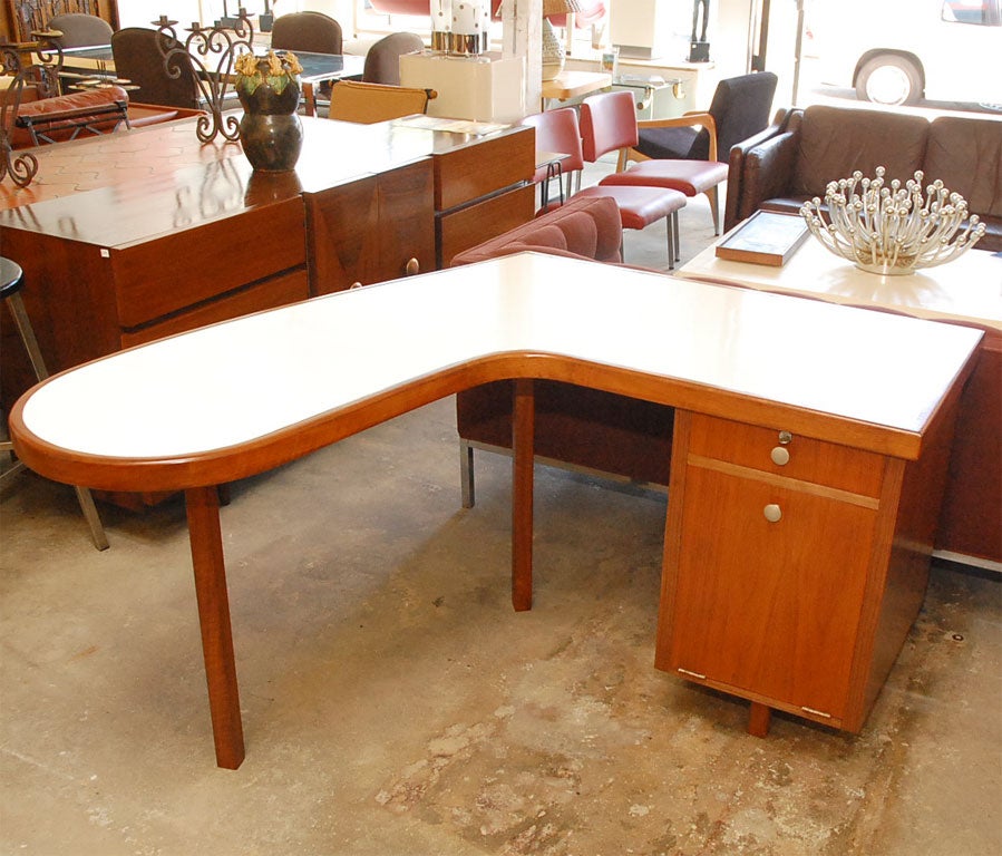 This desk is made of walnut with a white formica top.