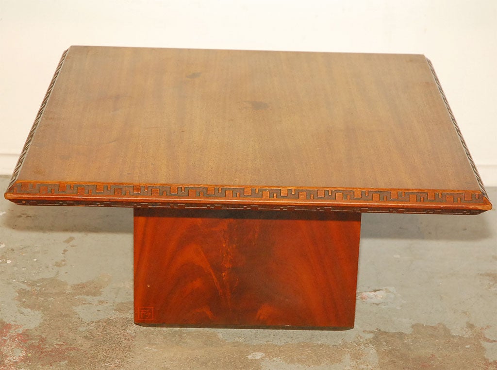 A simple square coffee table designed by Frank Lloyd Wright (when he was 86) for Heritage Henredon, as part of a famous collection called 
