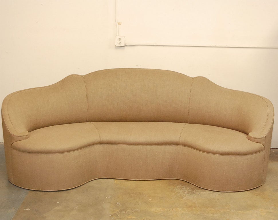 Originally this sofa was designed by Syrie Maugham in the 1930's for Elsa Schiaparelli the legendary Paris Fashion designer. Rediscovered and reproduced by (the also legendary) San Francisco designer Michael Taylor. Recently reupholstered in brown