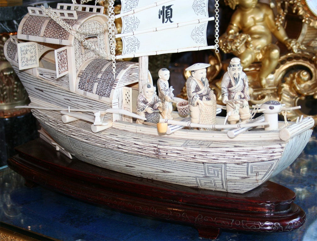 The Large Boat with a moving sailing bears the inscription Yi Hang Feng Shun (Wishing for a Favorable Wind). Two Fisherman with a Net and Pole Stand on the Bow, two boys with baskets are in the middle, and a woman occupies the Cabin. The Cabin has a