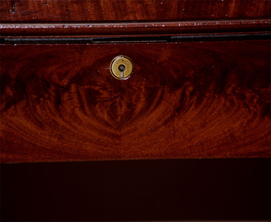 A very nice large-scale William IV pedestal sideboard made of choice mahogany solids and crotch mahogany veneers. The sideboard still retains many of the late Regency tendencies to present large blocked planes of wood and an almost architectural