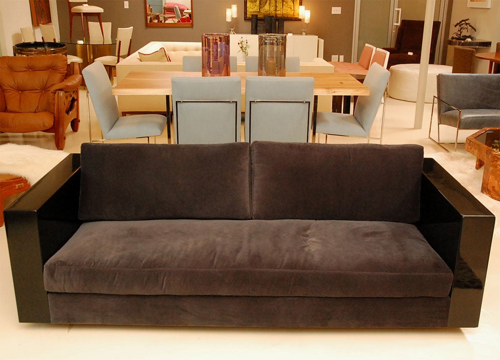 Modern black lacquered sofa with new upholstery.