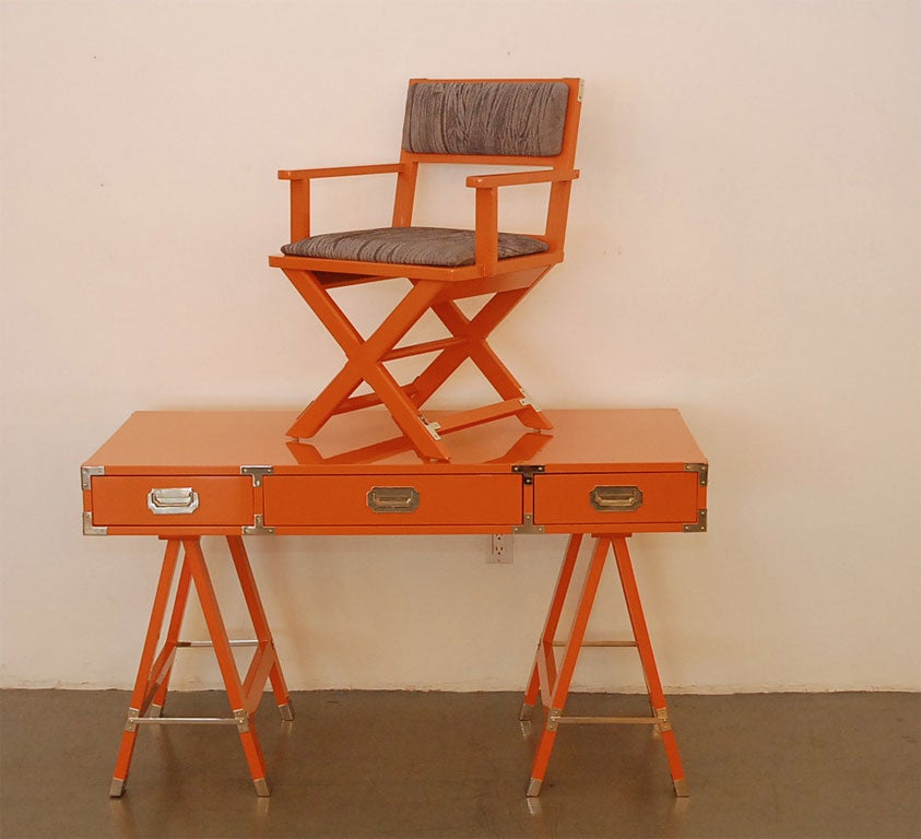 Campaign desk lacquered  in tangerine with  polished  nickel hardware and  seat  reupholstered  in grey snakeskin leather.