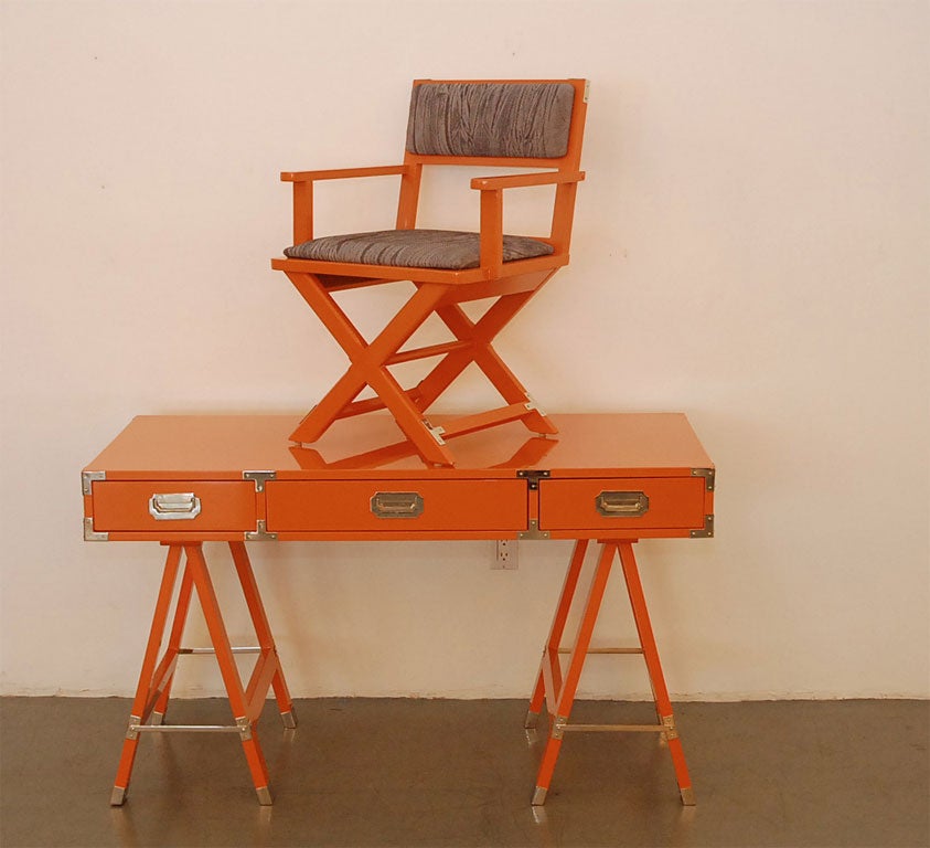 Campaign desk lacquered  in tangerine with  polished  nickel hardware and  seat  reupholstered  in grey snakeskin leather.