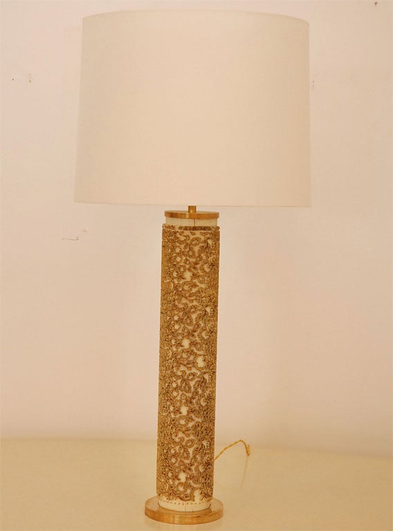 Oversize wallpaper roller lamp with intricate motif.