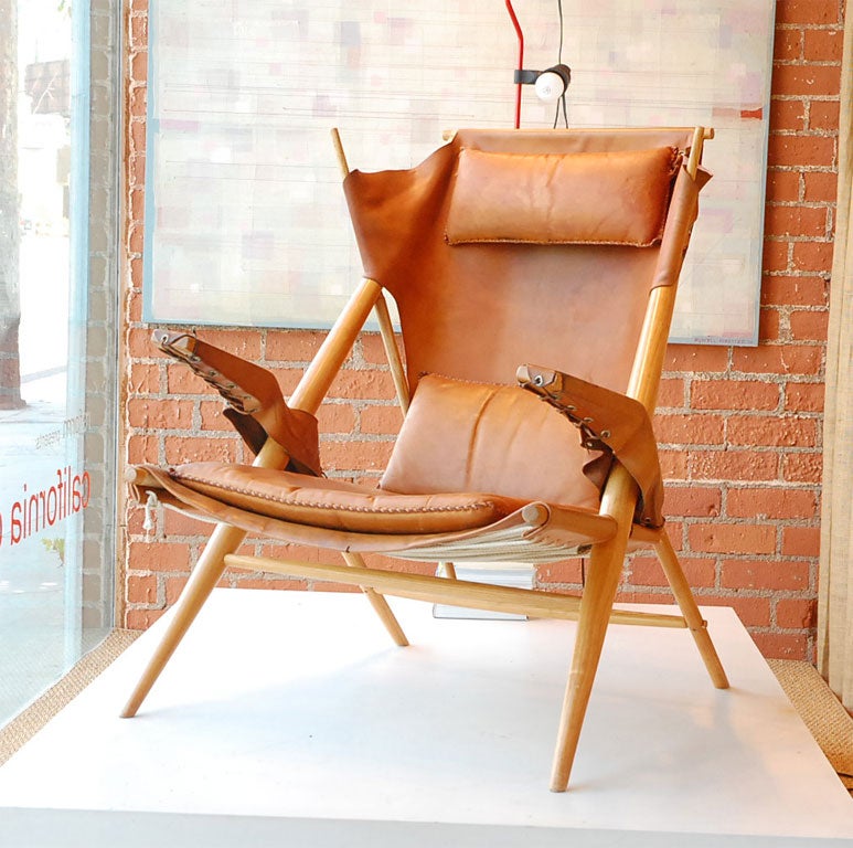 Unique leather-wrapped, high back wooden chair. with whip stiched pillows, completely demountable.  In the manner of Albini or Molino.