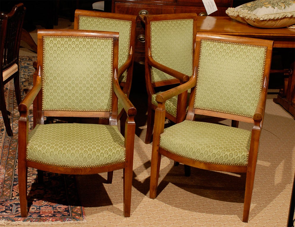 Set of four Empire walnut armchairs, Circa 1830