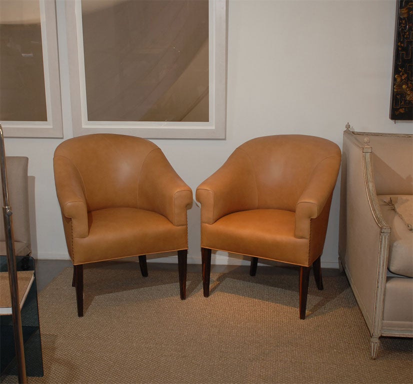 Newly reupholstered in leather with nail head detail, legs are palissandre wood