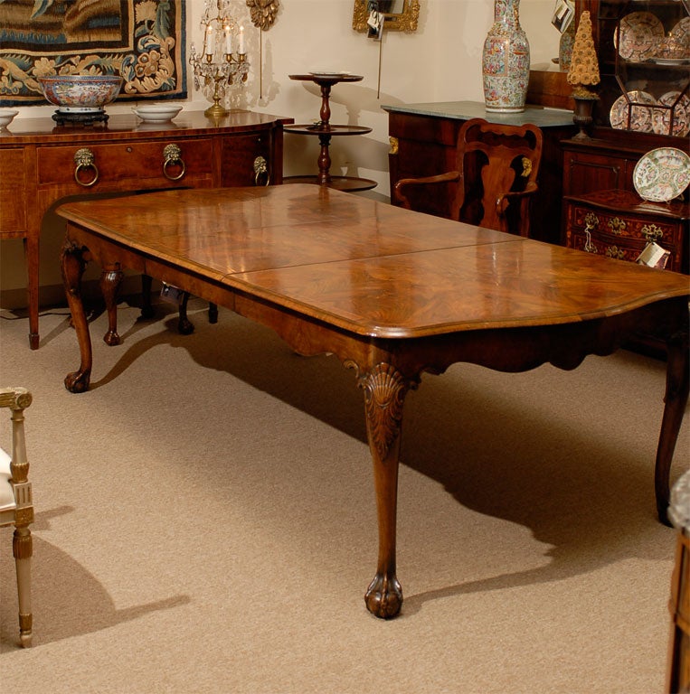 A Georgian Style Walnut Inlaid Dining Table with One Removable Leaf and Ball & Claw Foot, originating in England during the turn of the 20th century.<br />
<br />
For many more fine antiques, please visit our online galleries at: