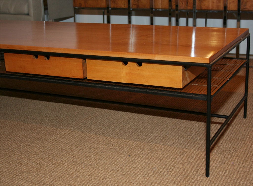 A scarce early Modernist cocktail table with a slab wood top, rustic round wrought iron frame, a bamboo slat lower shelf and two small storage drawers from the Planner Group line by Paul McCobb for Winchendon. U.S.A., circa 1950. [DUF0769] [DUF0770]