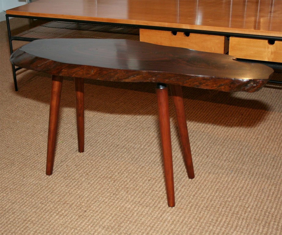 An expressive and diminutive handmade free edge occasional table with original paper label reading 'Fabulous tables sliced on the bias from forest trees' by Vermont artisan Roy Sheldon. U.S.A., circa 1960.