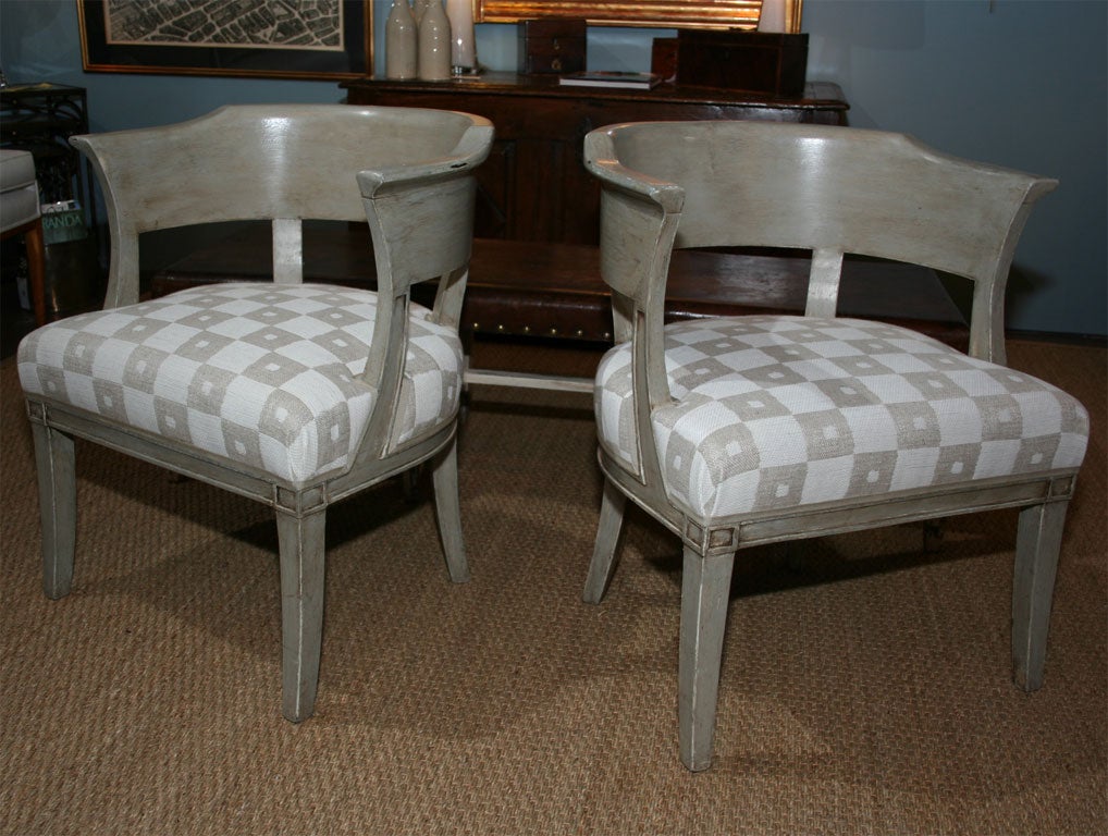 A pair of French painted armchairs with newly upholstered seats and curved, partially open back; from Eze sur Mer, southeast France.