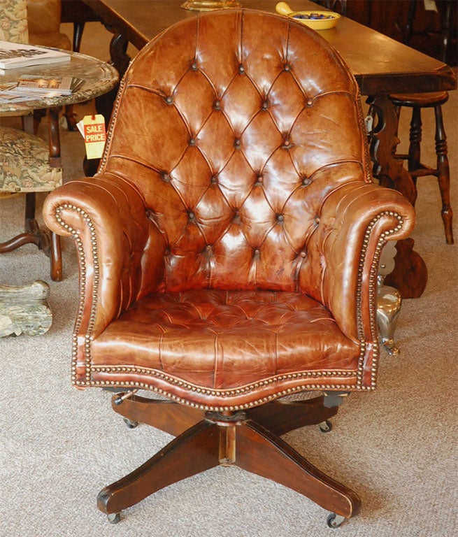 English leather desk chair with revolving mechanism.