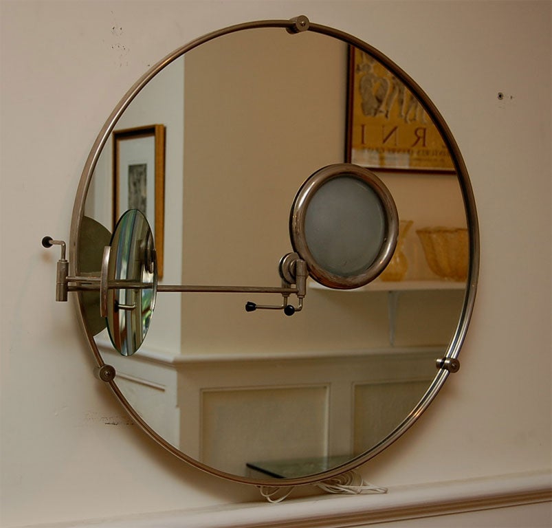 Round wall mirror with multi-adjustable magnifying mirror and light. The arm for magnifying mirror adjusts side to side and any angle from dual arms,then locks in place with levers.Round sphere in mirror lights.