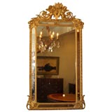 Antique French gold leaf mirror with putti and etched glass.
