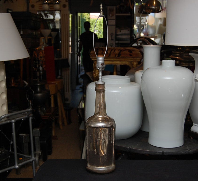 Antique mercury glass bottle wired as a lamp