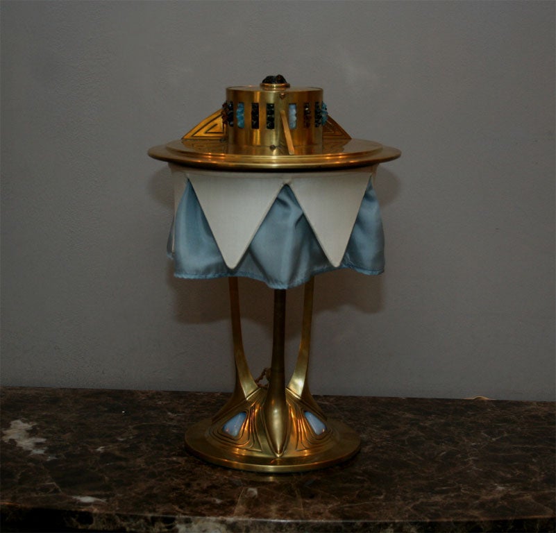 An Art Deco Austrian brass and jewel encrusted table lamp.
