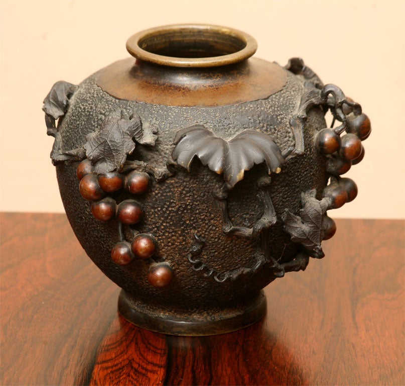 Bronze vase from late 19th century Japan, beautiful detailing in the metalwork and ornamentation of vine leaves and grapes.  Kanji signature on bottom