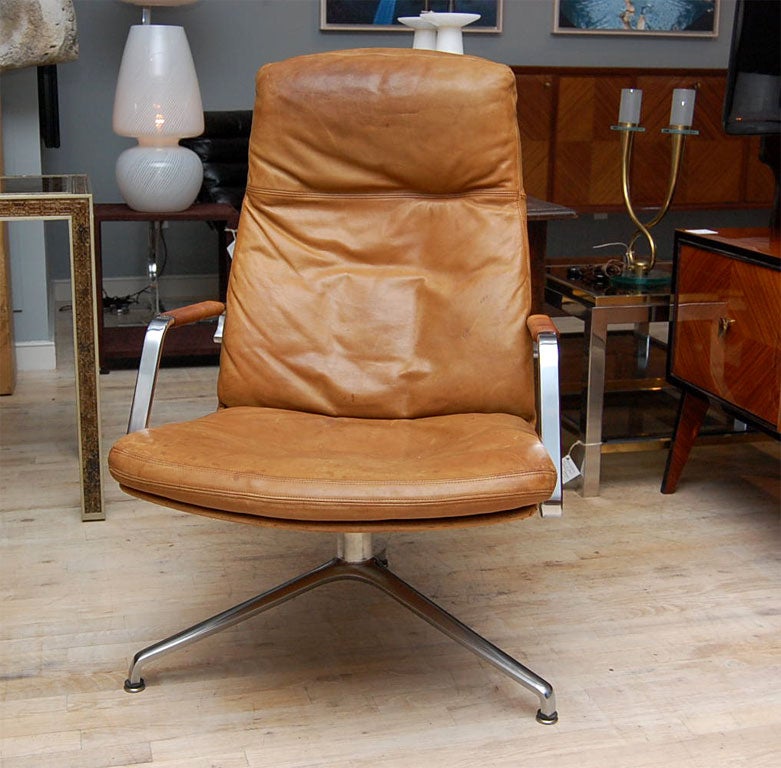 Down filled vintage leather upholstery with wound leather armrests. Polished steel frame.