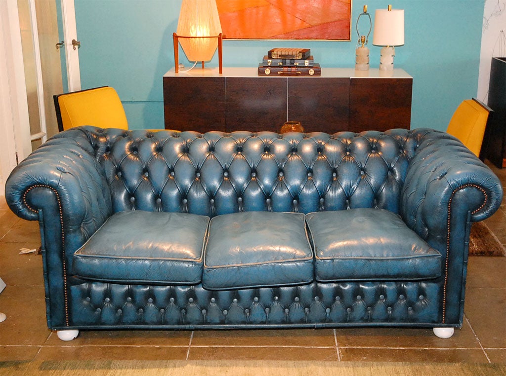 Great vintage blue leather Chesterfield.<br />
Nice lines. Incredible patina and color. Legs have been lacquered off-white.<br />
See other listing for matching chairs.