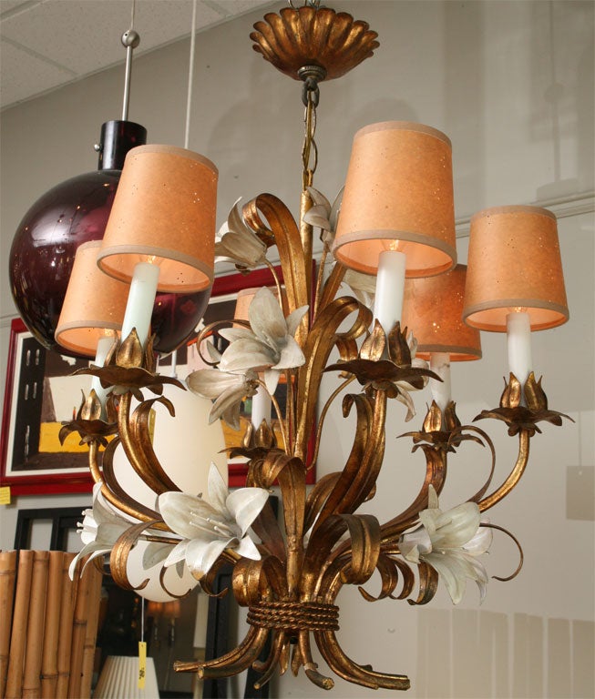 SOLD  Floral elegance reigns with this 1950's Italian tole six light chandelier.  Gloriously detailed enameled Lily blooms make up a bouguet along with gilt leaves, branching candle arms and petal bobeches.  Wonderful warm patina.  Very clean
