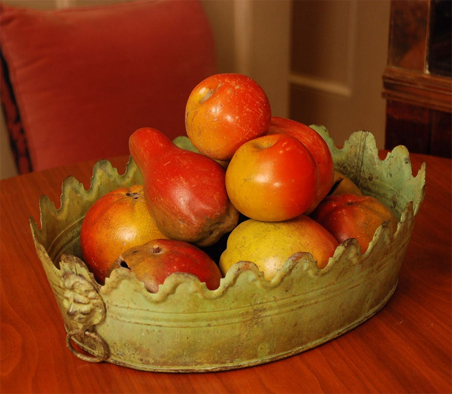 Green French tole monteith style bowl filled with a collection of English hand painted pottery banks and fruits.  The ten piece collection is made up of 6 fruit banks and 4 decorative fruits.