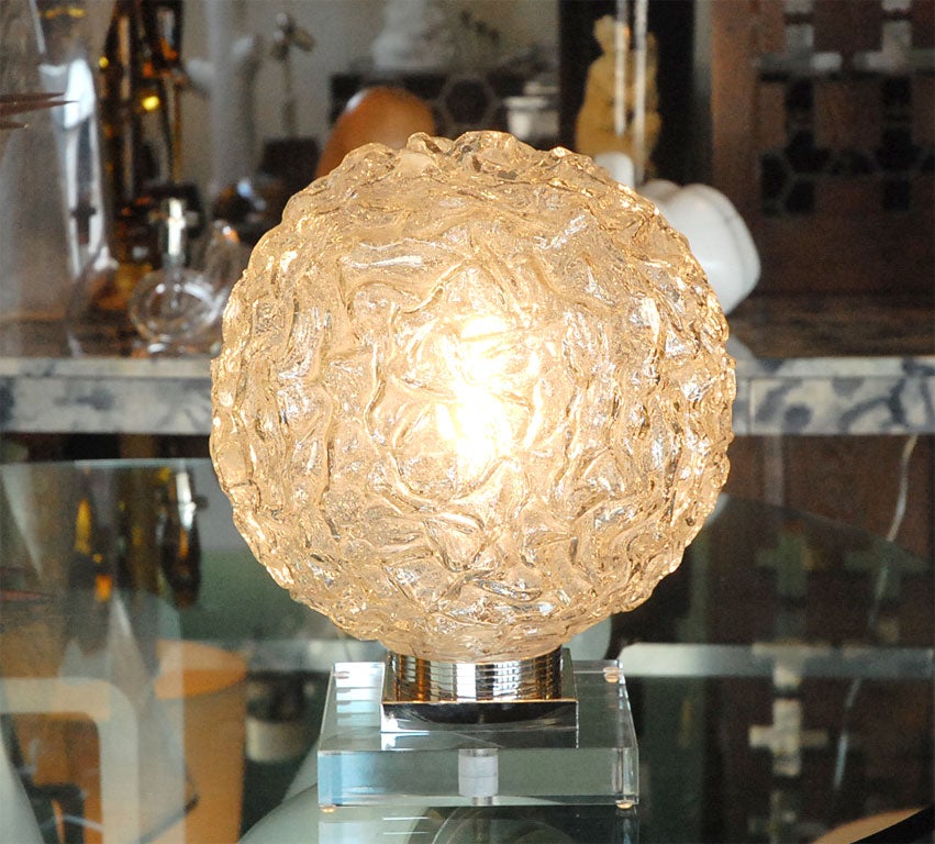 A midcentury German glass sphere mounted on new nickel and Lucite base.