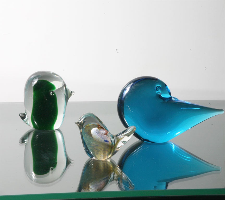 Murano glass birds ranging in scale and color.  The green mod bird on the left is by di Moreto and retains its original label.  They are all vintage and mint.  ... the green bird about 2 x 3 and the smallest 3 x 2 1/2.