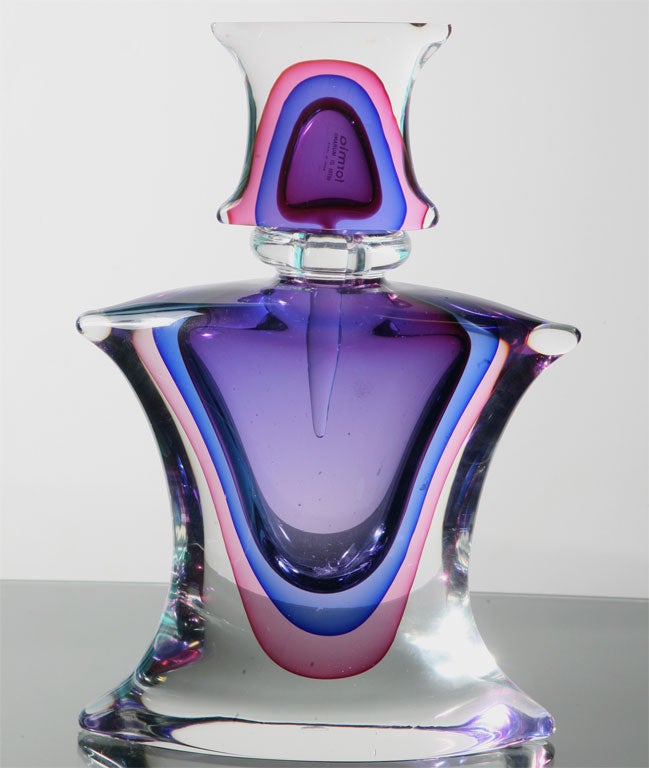 Glorious example of glassblowing from Murano. This perfume bottle is labeled Formia. It is heavy and impressive. The rainbow color palette ranges from cobalt blue to fuschia.