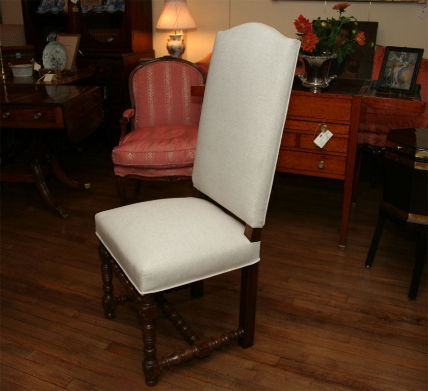 A set of eight French provincial fruitwood tall back dining chairs with lovely turned legs and stretcher, upholstered in linen
