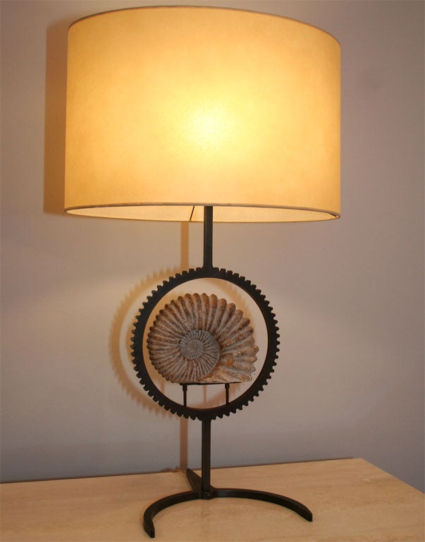 Our latest design, this lamp is made of cut bronze and holds in it's center a genuine Ammonite.<br />
This lamp is the sole of it's design as it is very intricate to produce. We can make another one if you wish a pair.