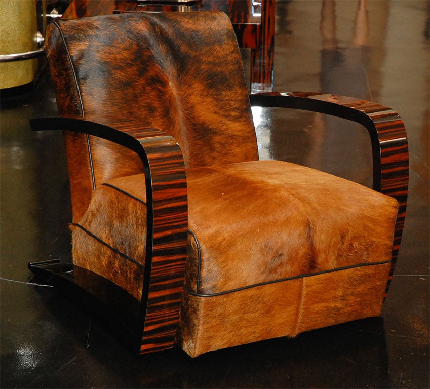 Pair of custom lounge chairs with arms in Macassar ebony and black lacquer and custom upholstery. Shown here in brown cow hide with black leather trim. 

Please note the price below does NOT include fabric or leather options. 