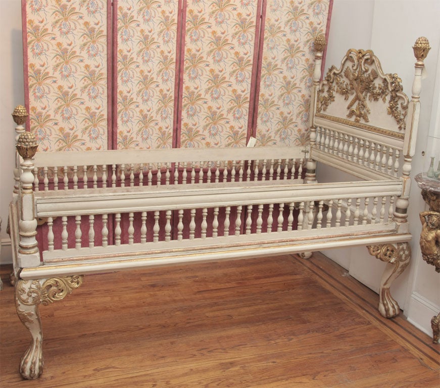 A  painted and gilded wood bed