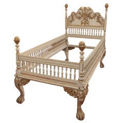 A  painted and gilded wood bed