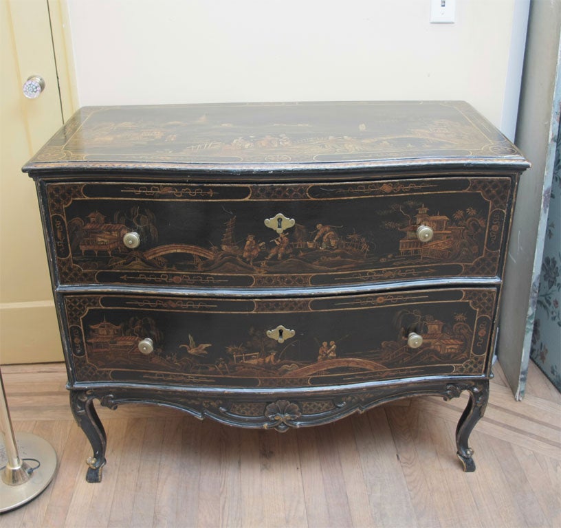 This chest-of-drawers is decorated overall with chinoiserie landscapes with courtly figures following leisurely pursuits, and of peasants, within borders with trellis cartouches and fields with spears and flowers, all on a black ground in imitation