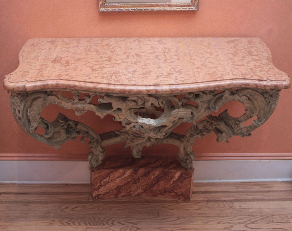 A painted wood console table with marble top